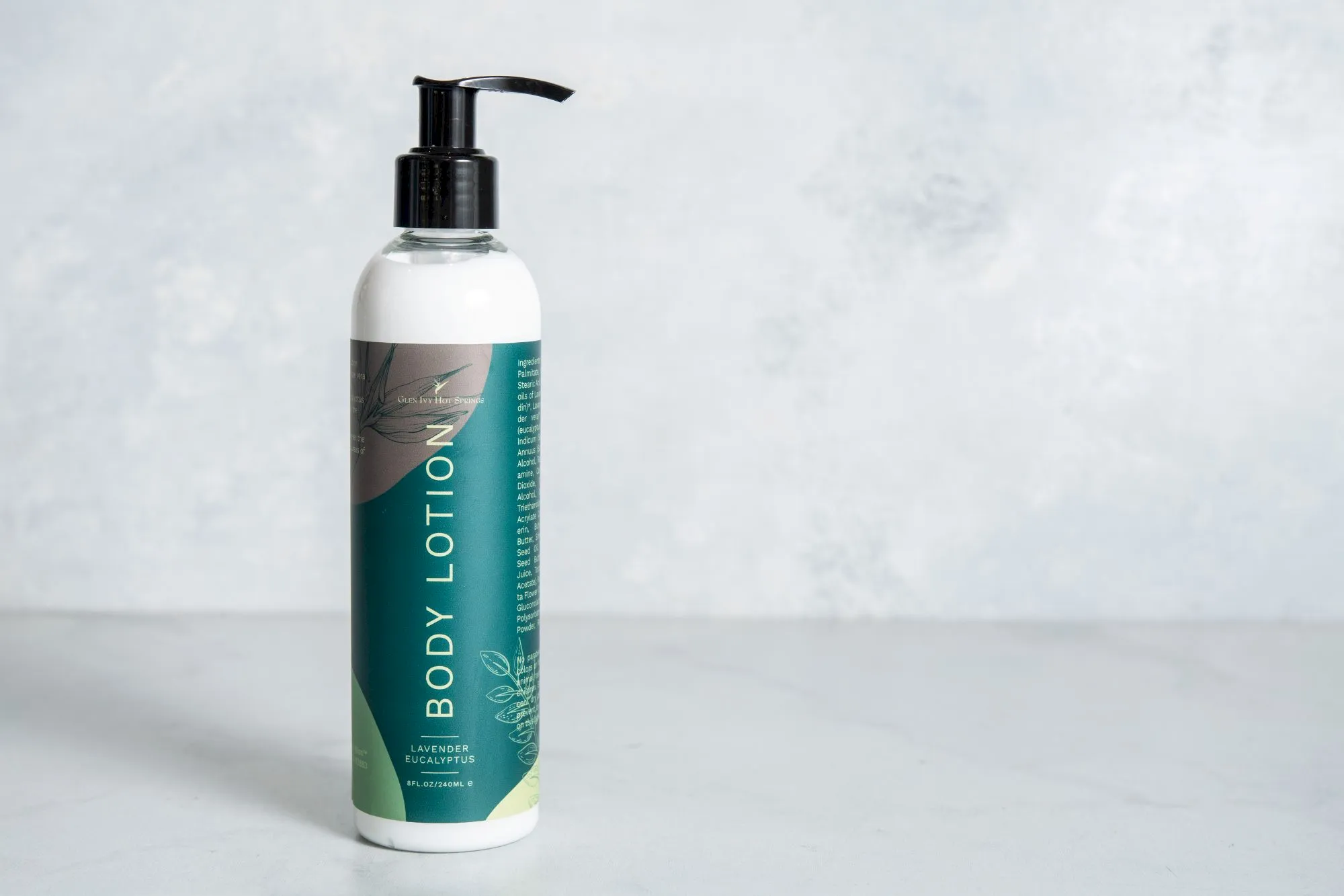 A bottle of body wash/soap labeled &ldquo;BODY LOTION,&rdquo; with a black pump, set on a light background.