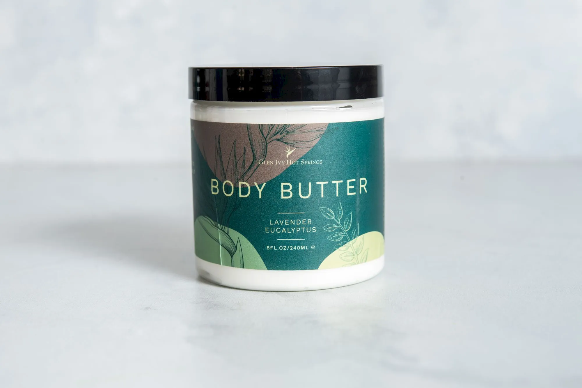 A &ldquo;Glen Ivy Hot Springs&rdquo; Body Butter jar labeled Lavender Eucalyptus, with a black lid and botanical design.